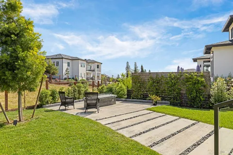 a view of a patio with a table and chairs and potted plants