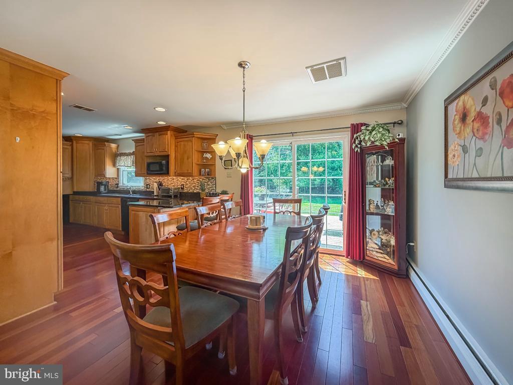 925 Big Oak Road Yardley, PA 19067 - Photo 14 of 51 a dining room with furniture a chandelier and wooden floor