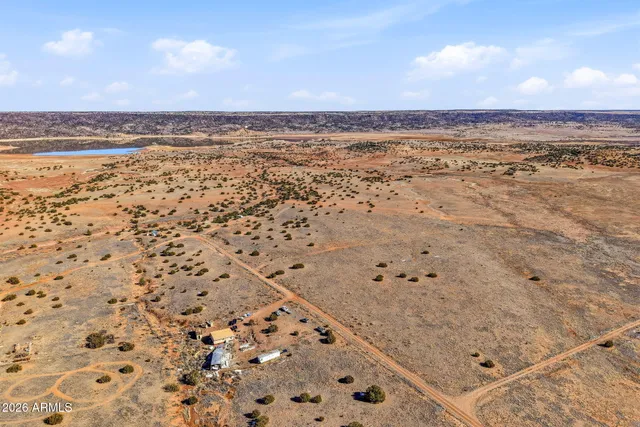 a bathroom with a granite countertop sink and mirror