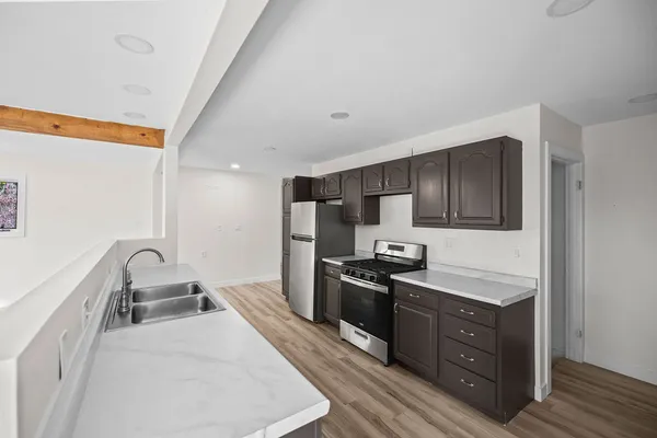 a kitchen with wooden cabinets and stainless steel appliances