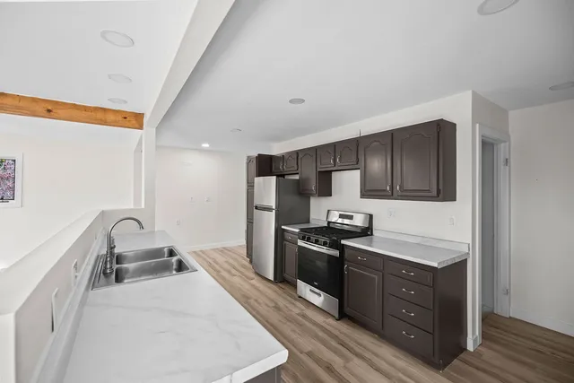 a kitchen with wooden cabinets and stainless steel appliances