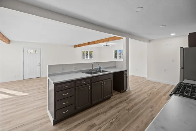 a spacious bathroom with a granite countertop sink and a mirror