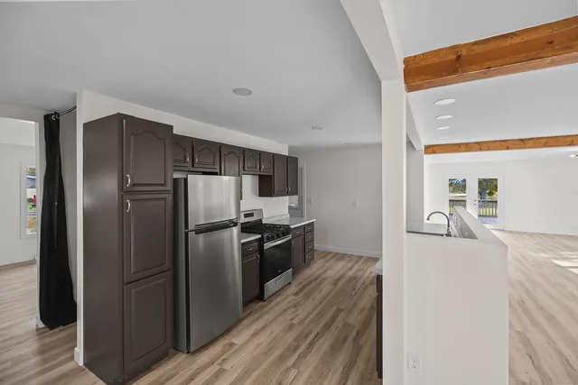 a kitchen with stainless steel appliances granite countertop a refrigerator and a sink