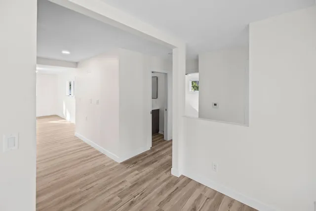 a view of hallway with wooden floor