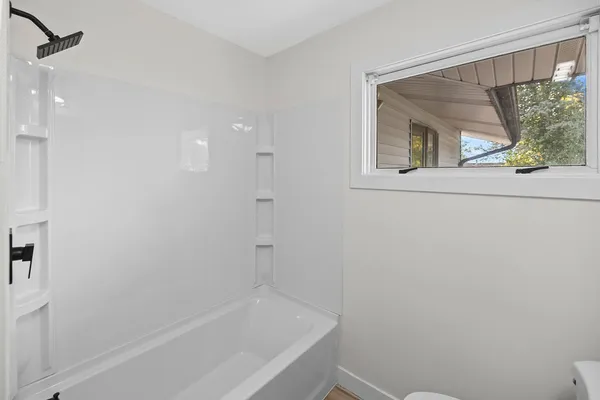 a bathroom with a bathtub and shower
