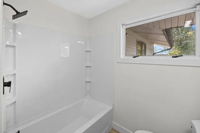 a bathroom with a bathtub and shower