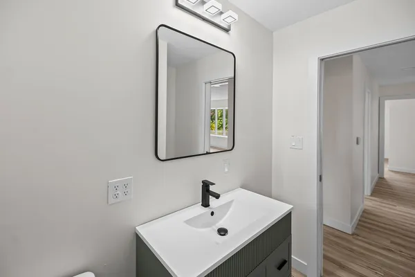 a bathroom with a sink and mirror