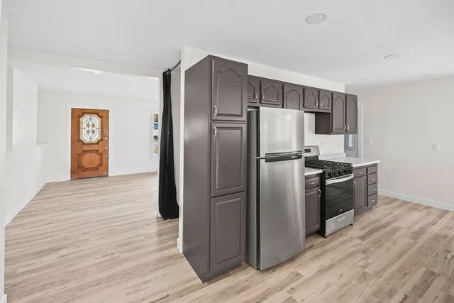a kitchen with stainless steel appliances granite countertop a refrigerator and a sink