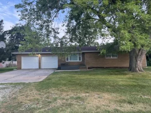 a view of a backyard with a large tree