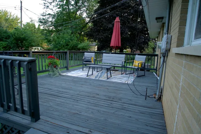 a view of a deck with table and chairs with wooden floor and fence