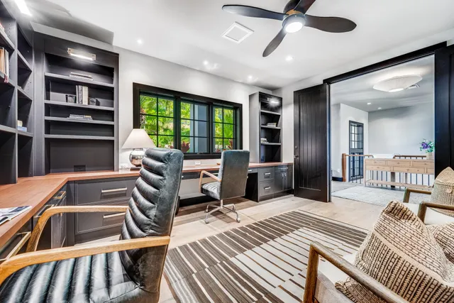 a bedroom with furniture and a large window