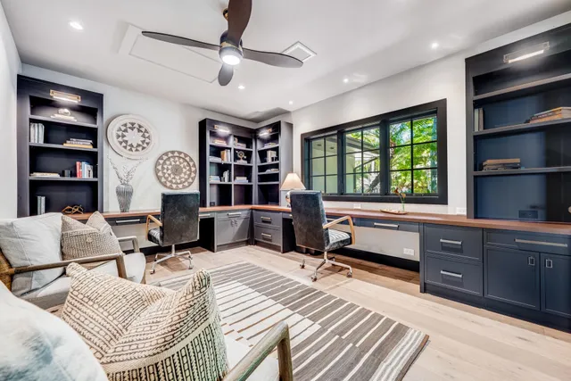 a bedroom with a bed furniture and a large window