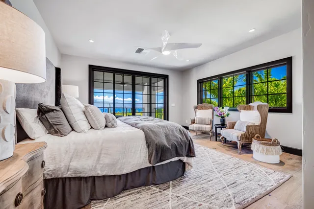 a bedroom with a bed and glass windows