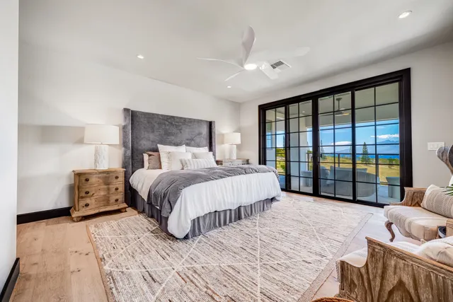 a spacious bedroom with a bed and a large window