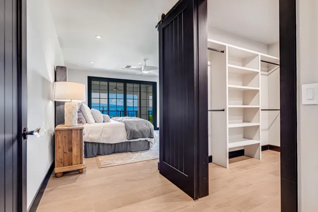 a bed room with a bed and a view of living room