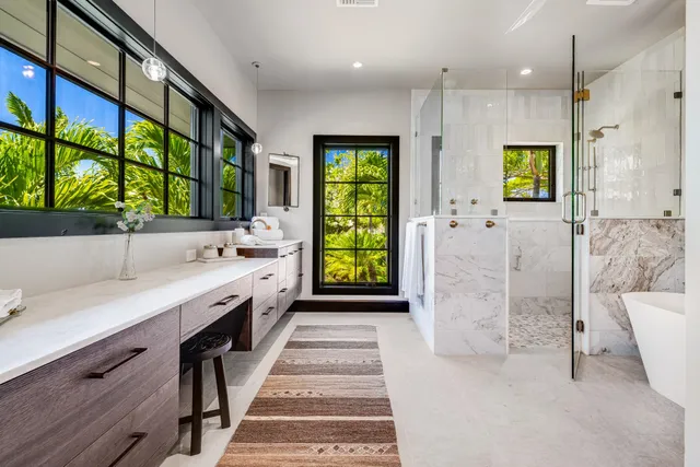 a large white kitchen with a large window