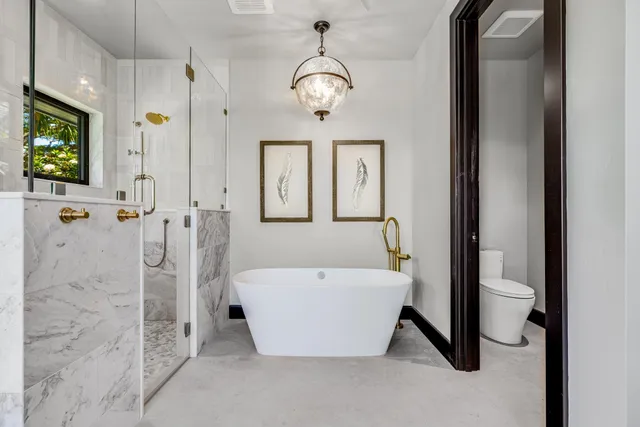 a spacious bathroom with a tub and a view of bathroom