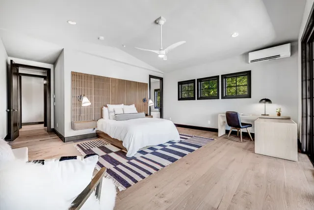 a bedroom with furniture and a chandelier