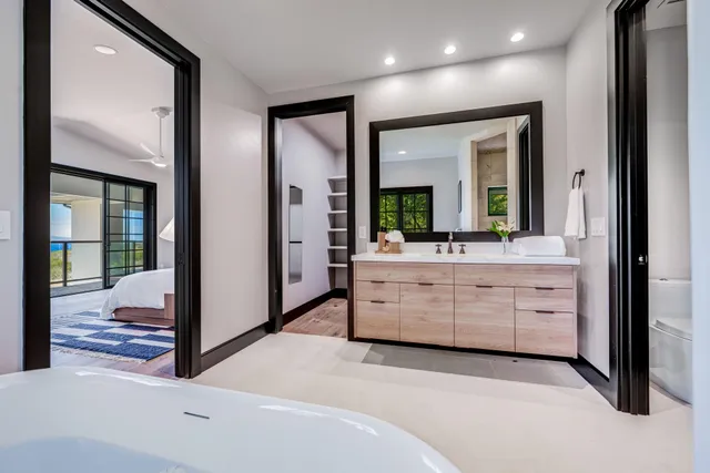 a view of a hallway with mirror and window