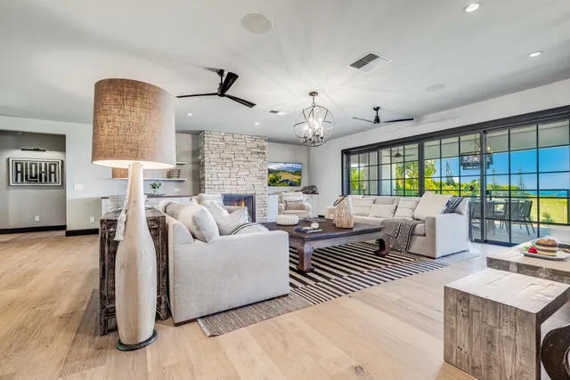 a living room with furniture and a floor to ceiling window