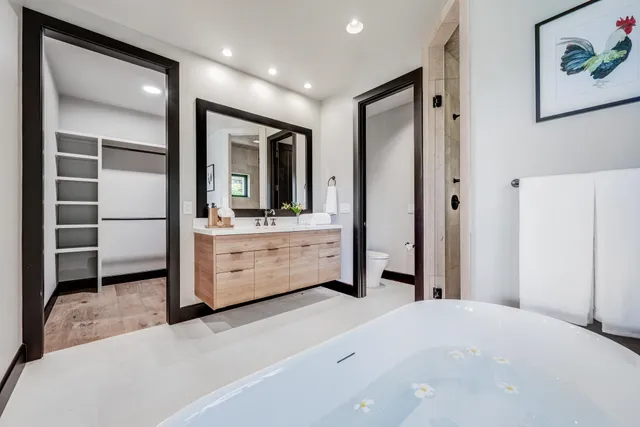 a bedroom with a bed and a large mirror