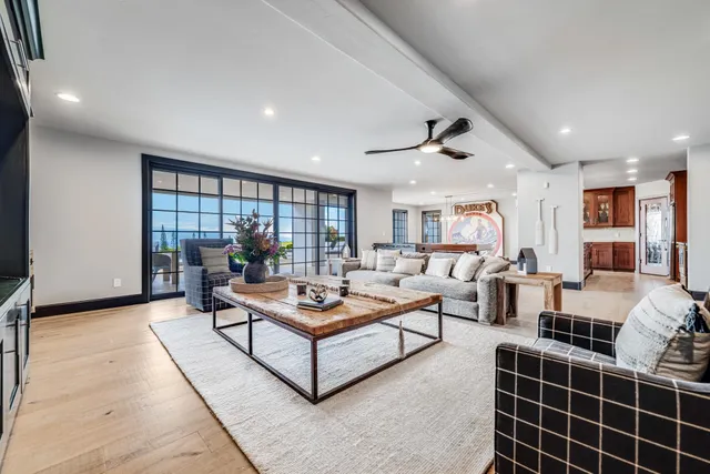 a living room with furniture a table and a potted plant