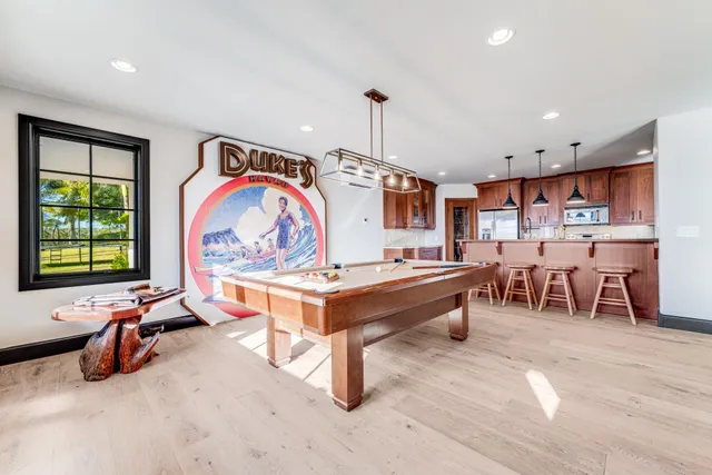 a living room with stainless steel appliances kitchen island granite countertop furniture and a large window