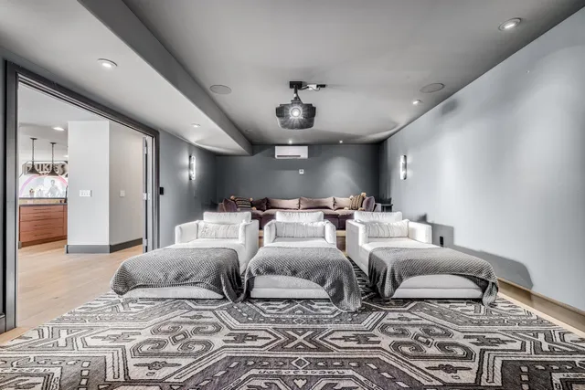 a large bedroom with two beds and a chandelier