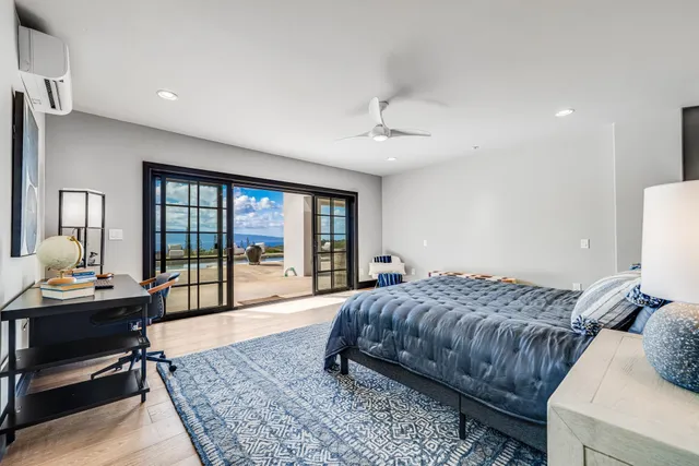 a bedroom with a bed a table and chairs