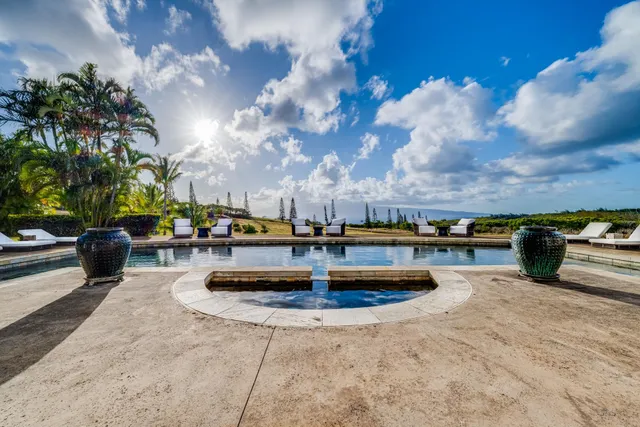 a view of a swimming pool with outdoor seating