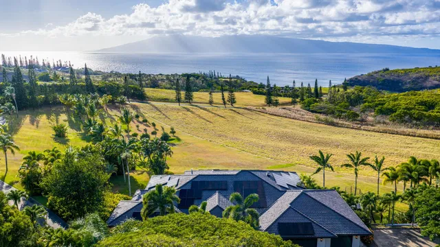 a view of swimming pool with a table and chairs under an umbrella