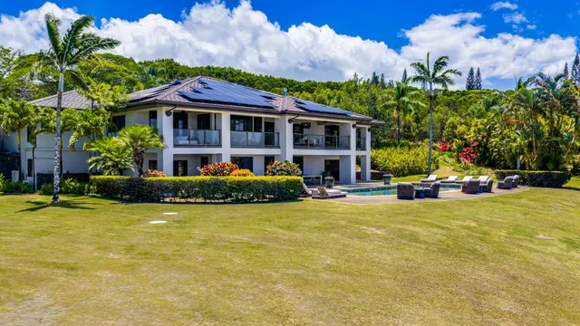 a view of a house with swimming pool and sitting area