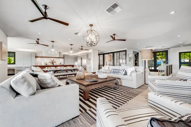 a living room with furniture and a chandelier
