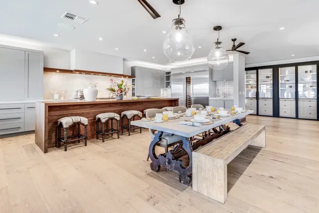a large kitchen with a table and chairs