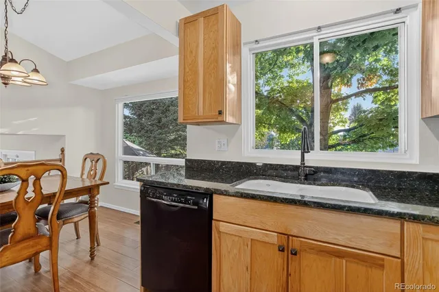 a kitchen with granite countertop sink stove and dining table