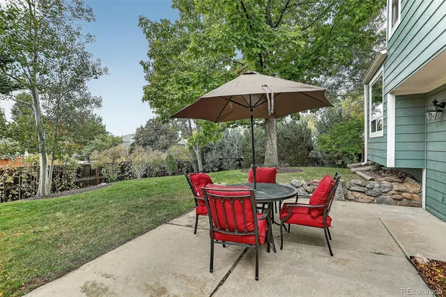 a view of a table and chairs under an umbrella