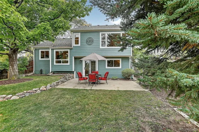 a view of a house with a yard and sitting area