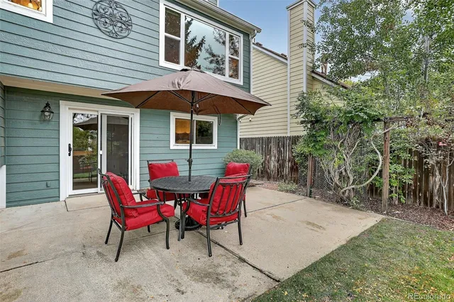 a view of a house with backyard and sitting area