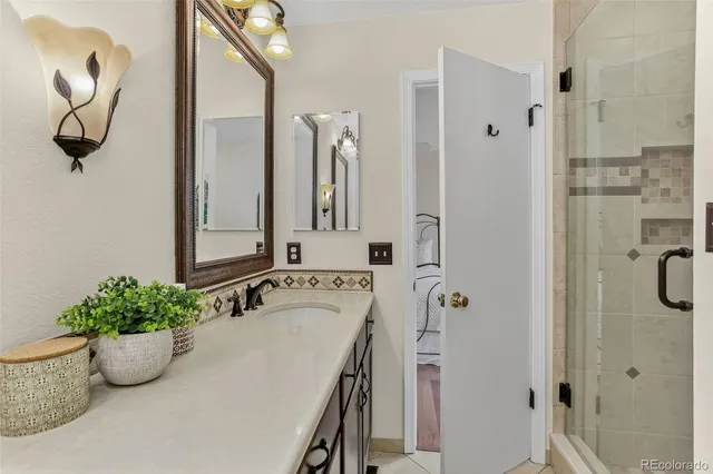 a bathroom with a tub shower and mirror