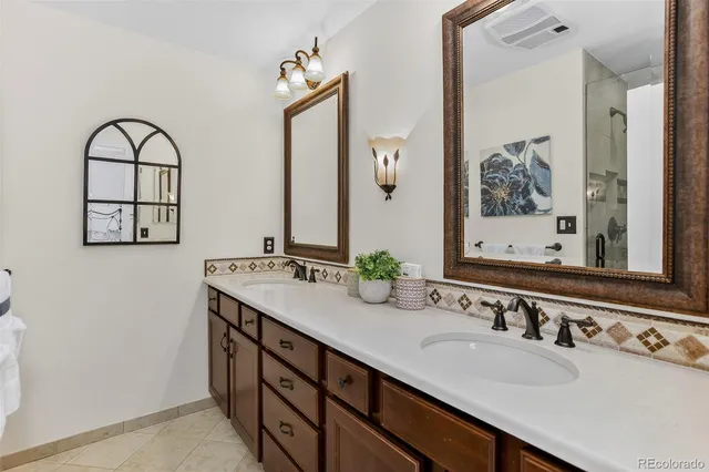 a bathroom with a double vanity sink mirror and double