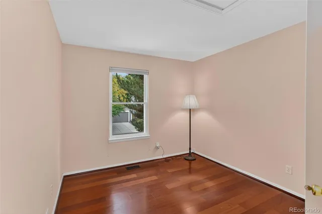 a view of a room with wooden floor and a bathroom