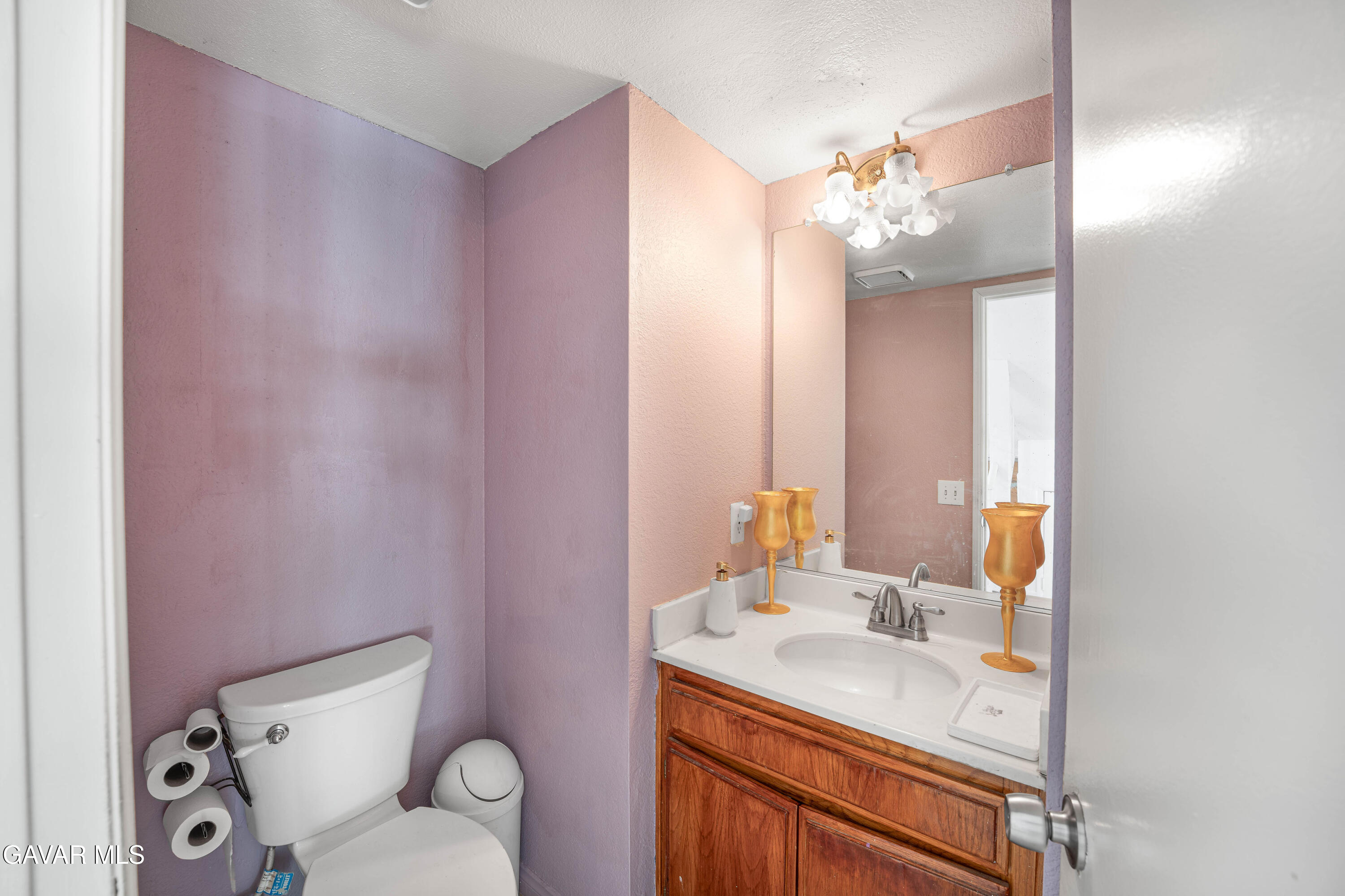 5009 East Ave R 11 Palmdale, CA 93552 - Photo 6 of 23 a bathroom with a sink vanity mirror and toilet