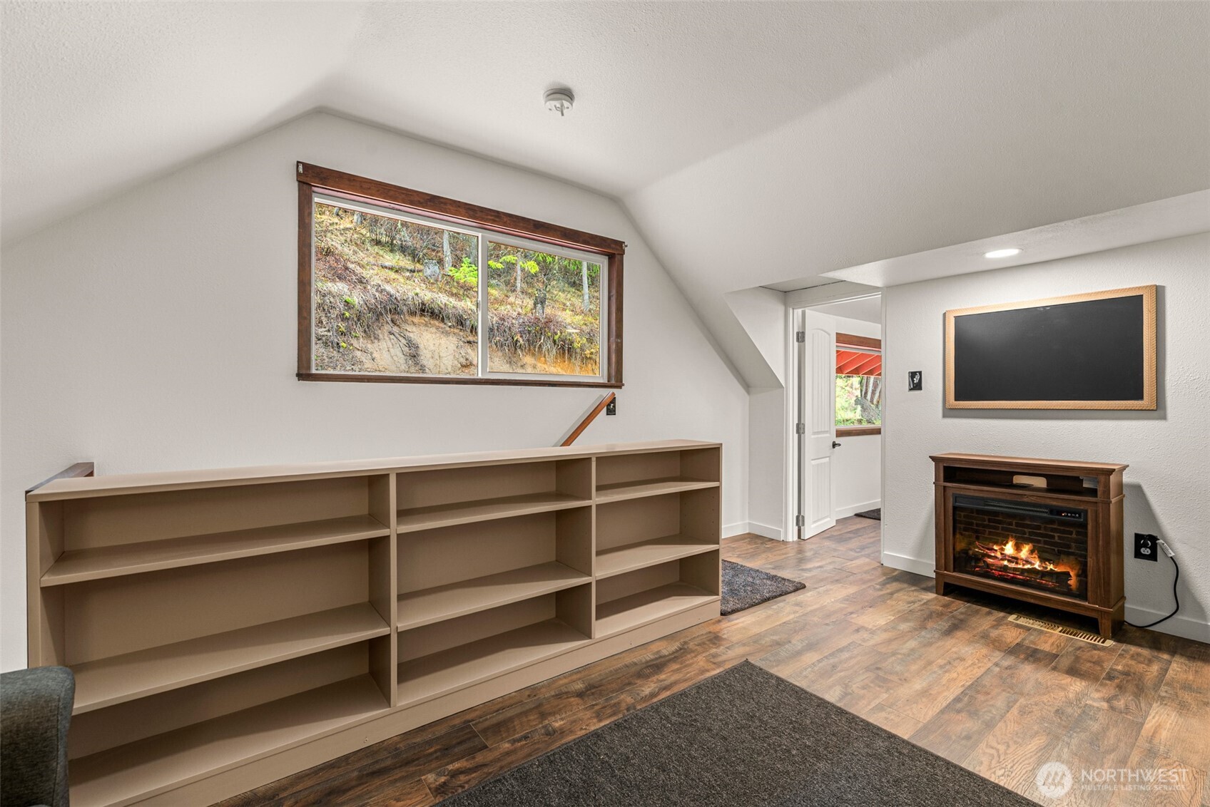 695 Sand Creek Road Cashmere, WA 98815 - Photo 25 of 40 a living room with furniture a flat screen tv and a fireplace