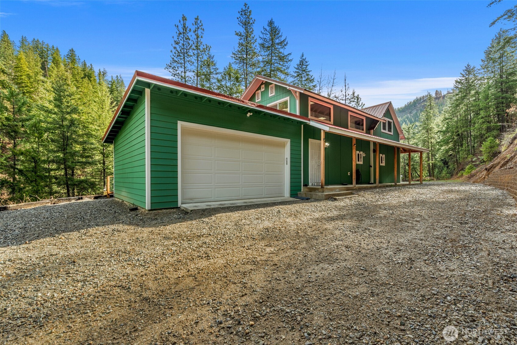 695 Sand Creek Road Cashmere, WA 98815 - Photo 35 of 40 a front view of a house with a yard and garage