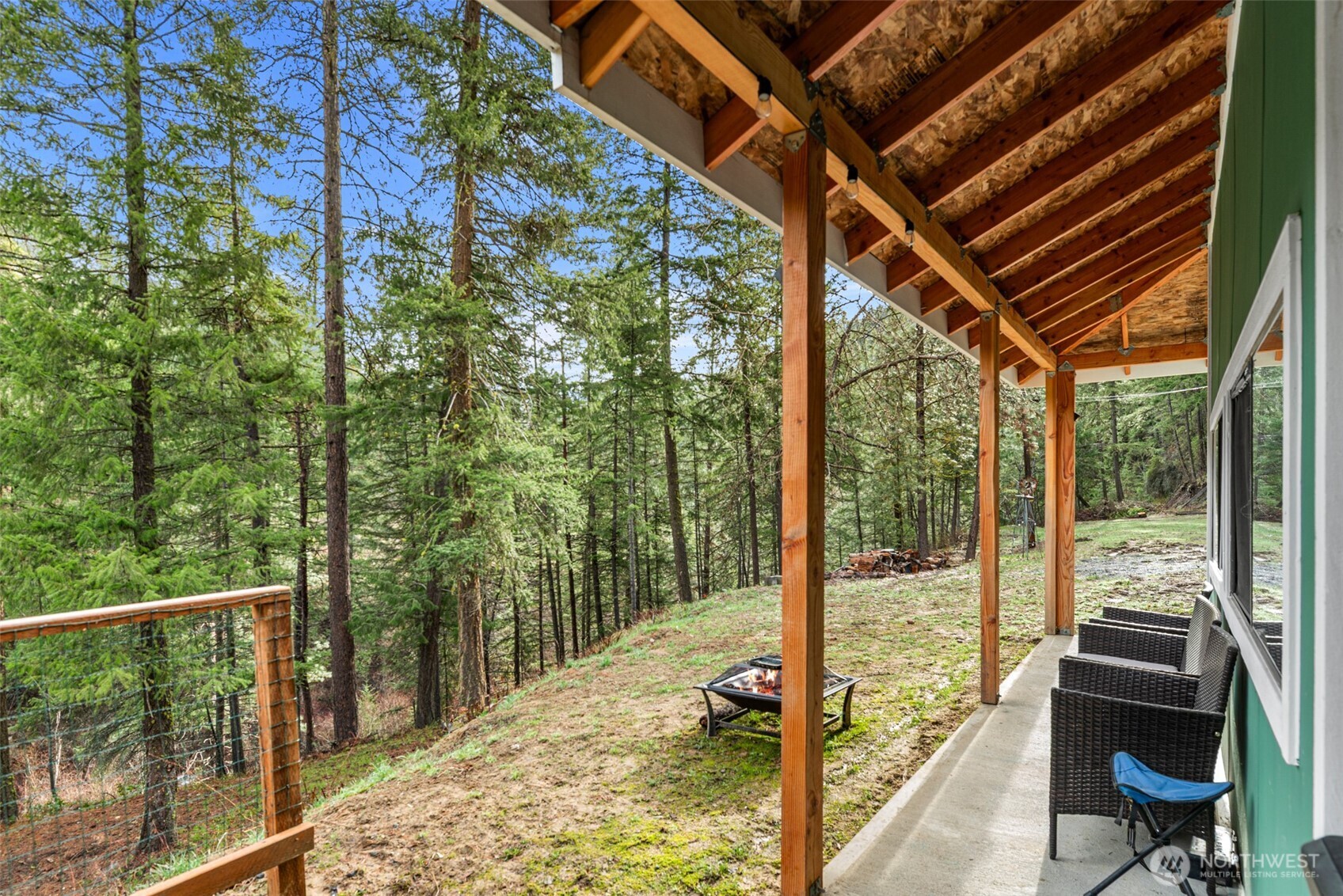 695 Sand Creek Road Cashmere, WA 98815 - Photo 10 of 40 a view of a balcony with chairs and floor to ceiling window