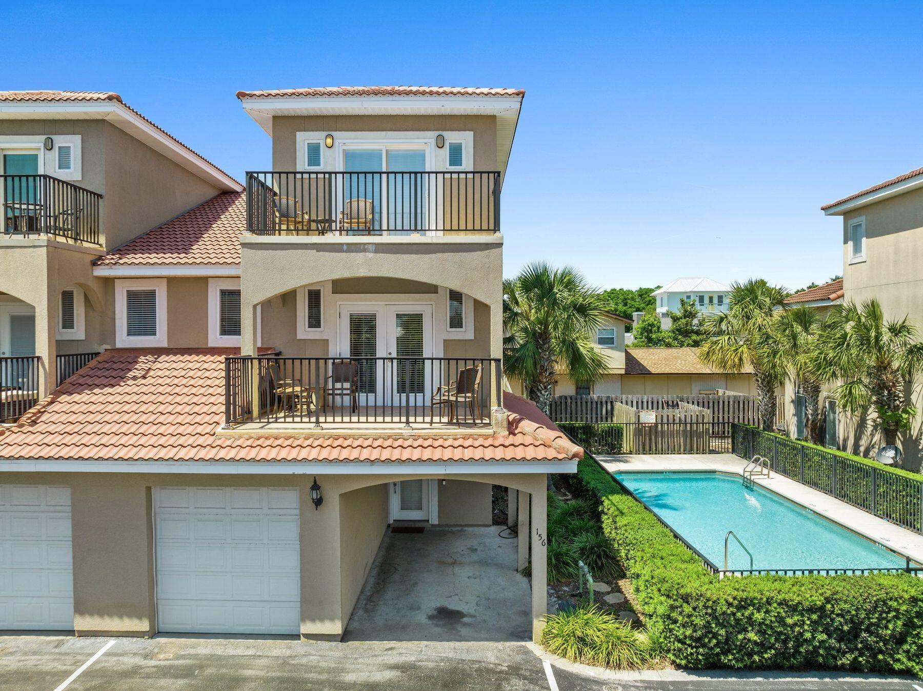 156 Southfields Road Panama City Beach, FL 32413 - Photo 1 of 35 front view of a building with a swimming pool