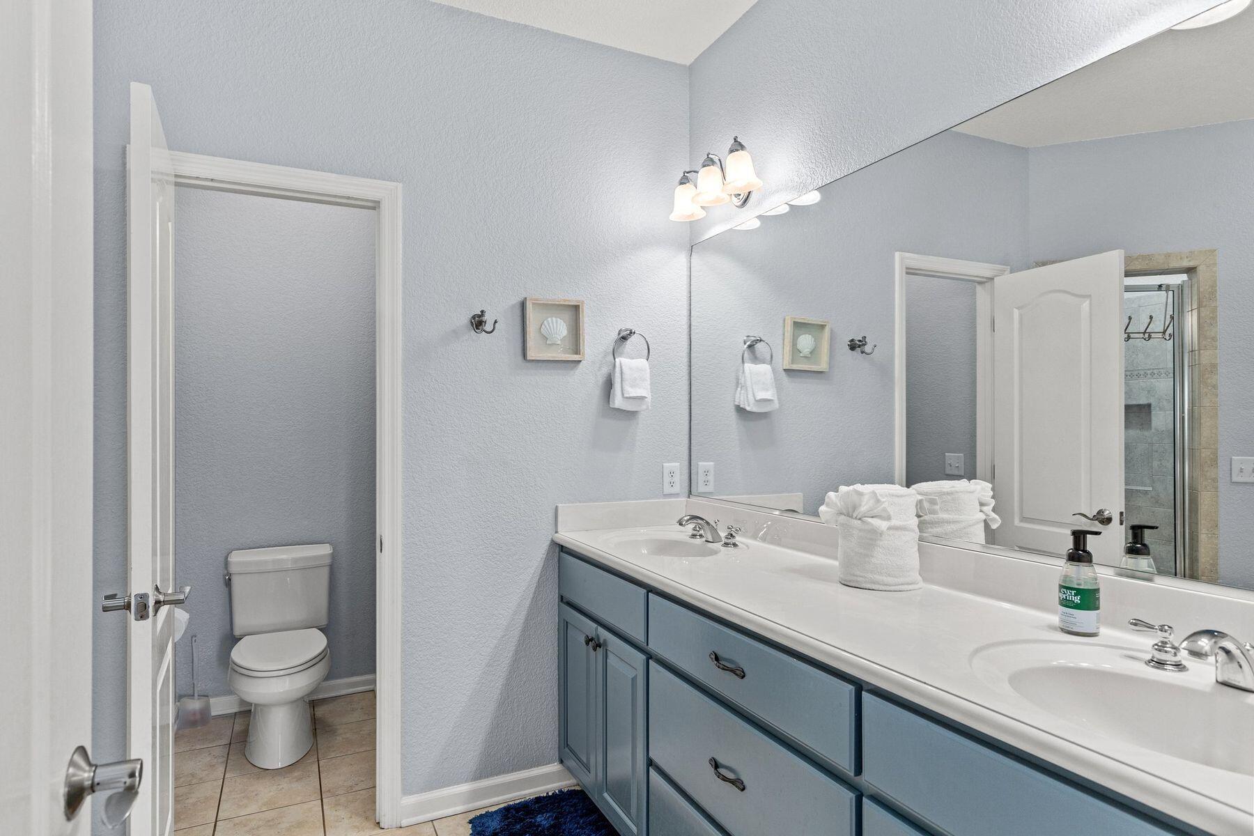 156 Southfields Road Panama City Beach, FL 32413 - Photo 19 of 35 a bathroom with a toilet a sink and mirror