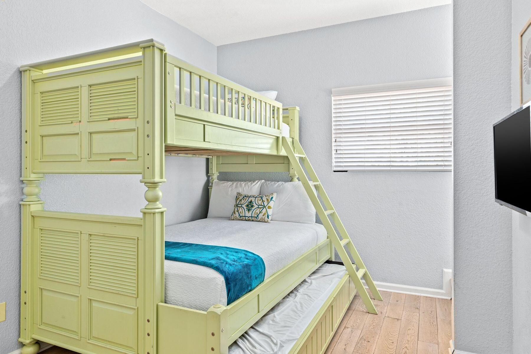 156 Southfields Road Panama City Beach, FL 32413 - Photo 21 of 35 a bedroom with a bed and a flat tv screen on dresser