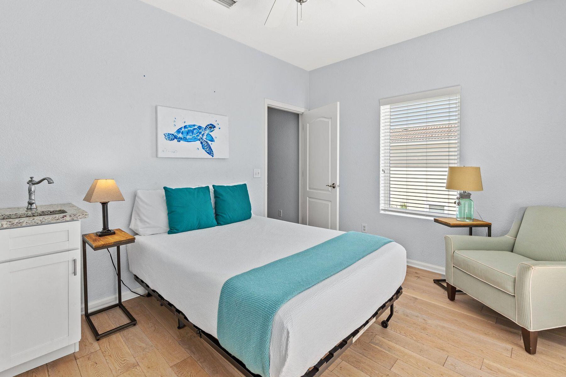 156 Southfields Road Panama City Beach, FL 32413 - Photo 23 of 35 a bedroom with a bed wooden floor and lamp