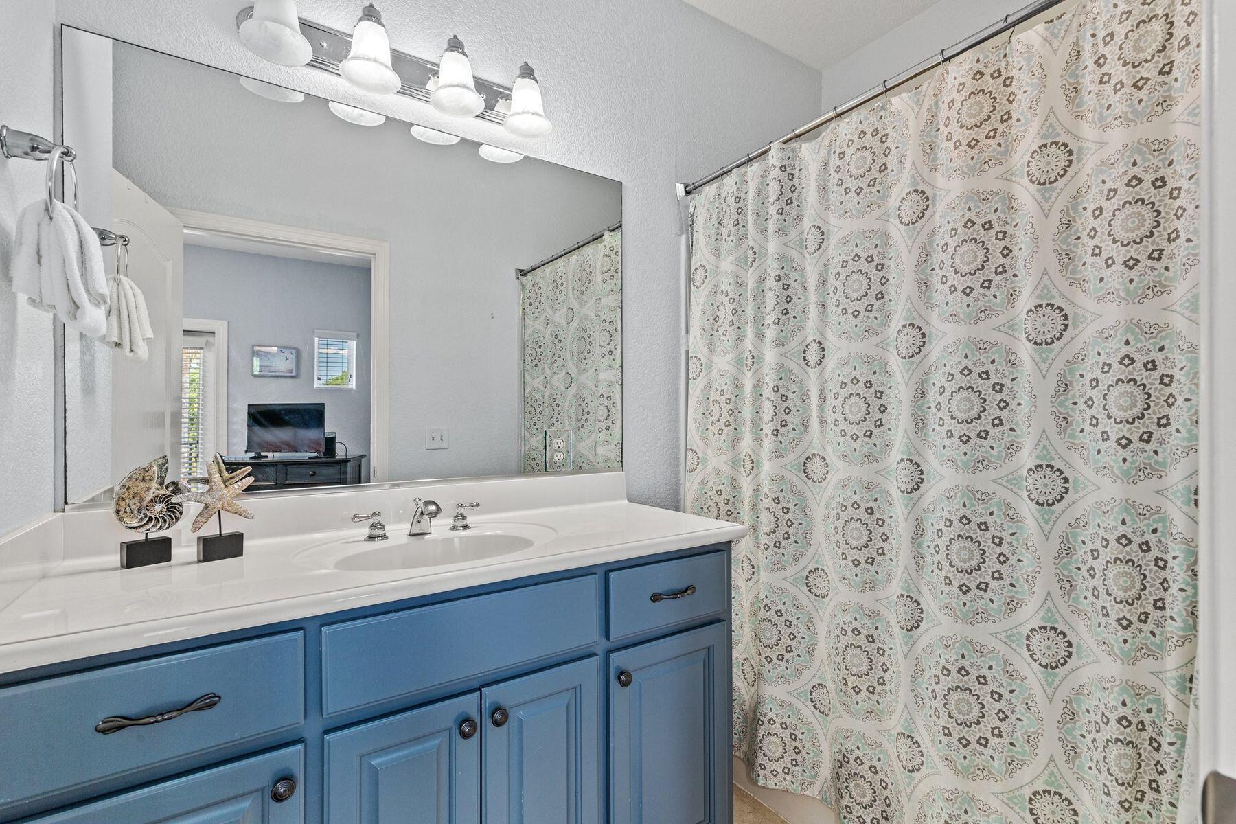 156 Southfields Road Panama City Beach, FL 32413 - Photo 24 of 35 a bathroom with a double vanity sink mirror and shower
